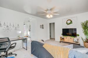a living room with a couch and a ceiling fan at Charming Pottstown Apartment - Walk to Town! in Pottstown