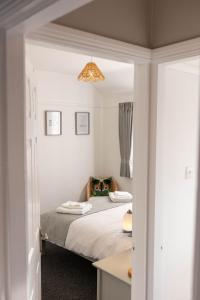 a bedroom with a bed and a desk at 68 Glenwood Road in Ellesmere Port
