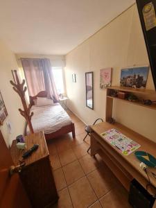 a small room with a bed and a table at Departamento Vina Centro (Portal Álamo) in Viña del Mar +7 photos