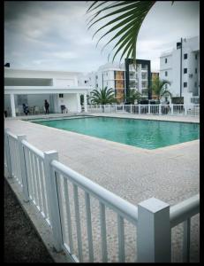 a swimming pool next to a white fence at Palmer in Santiago de los Caballeros