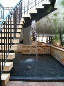 a water fountain in a building with a staircase at Hotel San Jeronimo in Popayan