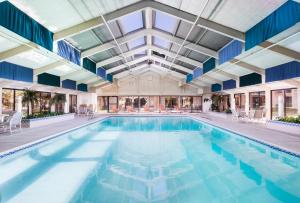 an indoor pool with blue water in a building at The Querque Hotel in Albuquerque