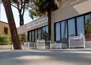 a building with white chairs in front of it at Hotel Miramare - SPA & Suites - Free Brunch & Breakfast Until 13-00 in Cervia
