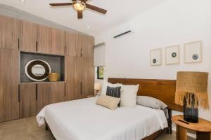 a bedroom with a white bed and a ceiling fan at Casa Gallo, Luxurious Private 3Bd Villas in the heart of Cabo in Cabo San Lucas