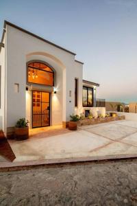 a large white house with a large door at Casa Gallo, Luxurious Private 3Bd Villas in the heart of Cabo in Cabo San Lucas