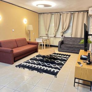 a living room with two couches and a table at Happy Home in Eilat