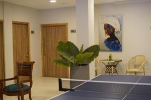 ein Wohnzimmer mit einem Tisch und einem Gemälde einer Frau in der Unterkunft DORADO PLAZA GETSEMANI in Cartagena de Indias