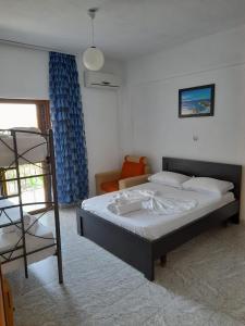a bedroom with a bed and a ladder and a bunk bed at Villa Festim Ksamil in Ksamil