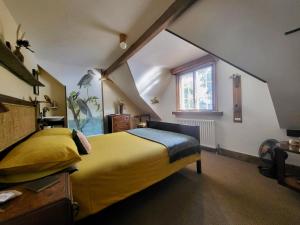 a bedroom with a yellow bed and a window at Aviemore Rye in Rye