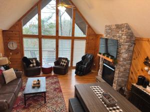 a living room with a couch and a fireplace at Lazy Bear Den in Sevierville