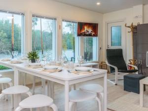 a dining room with a white table and chairs at Holiday Home Villa renkaranta by Interhome 