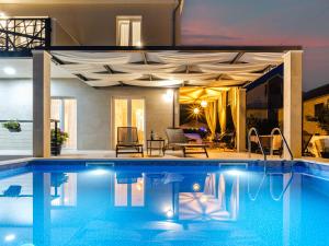 a swimming pool in a house with a ceiling at Holiday Home Villa Renesansa by Interhome in Milna
