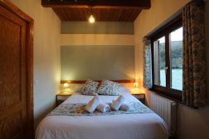 a bedroom with a bed with two pillows and a window at Bonita casa de montaña en el Pirineo Central in Escarrilla