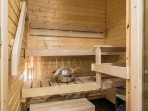 a sauna with wooden walls and wooden shelves at Holiday Home Levi chalet 1602 by Interhome in Sirkka