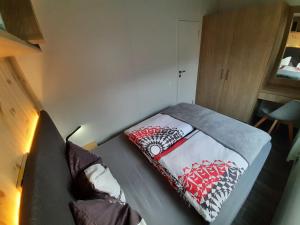 a small room with a bed and a couch at Holiday Home am Waldsee by Interhome in Wemding