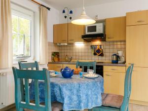 d'une cuisine avec une table et des chaises bleues. dans l'établissement Apartment Eickhus Blaue Wohnung by Interhome, à Zinnowitz
