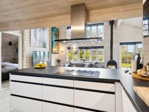 een keuken met witte kasten en een aanrecht bij Holiday Home Anemarie - all inclusive - 400m from the sea by Interhome in Karrebæksminde