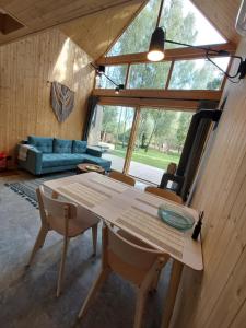 a living room with a table and a couch at Strefa ciszy Lubomin in Lubomin