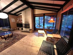 a living room with a couch and a table at Holiday Home Annemone - from the sea in Sealand by Interhome in Rørvig