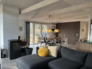 a living room with a couch and a table at Holiday Home Gretl in Western Jutland by Interhome in Arrild