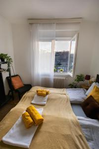 a bedroom with two beds with towels and a window at Cozy Panorama Apartment next to the Buda Castle in Budapest