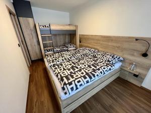 a bedroom with a large bed with a wooden headboard at Holiday Home Říčky v Orlických horách F39 by Interhome in Říčky
