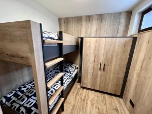 a room with two bunk beds and a cabinet at Holiday Home Říčky v Orlických horách F39 by Interhome in Říčky