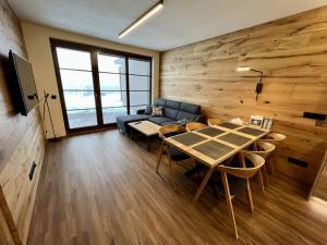 a living room with a table and a couch at Holiday Home Říčky F39 by Interhome in Říčky