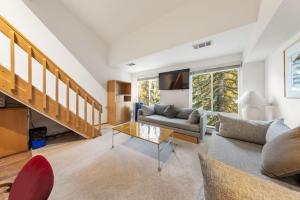 a living room with a couch and a table at Palisades Tahoe Lodge Rentals Studio Loft #308 in Olympic Valley
