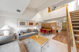a living room with a couch and a table at Palisades Tahoe Lodge Rentals Studio Loft #308 in Olympic Valley