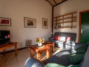 a living room with a couch and a table at Holiday Home zeewind by Interhome in Bredene