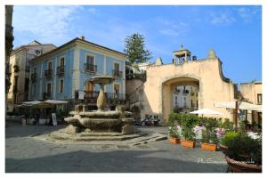 a fountain in a courtyard in front of a building at B&B La Piazzetta in Paola