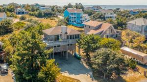 an aerial view of a large house with trees at Duck N Cover in Duck