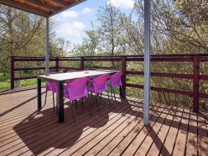 a table and purple chairs on a wooden deck at Holiday Home Mirja - 50m to the inlet in The Liim Fiord by Interhome in Fur
