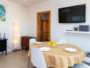 a dining room with a table with a bowl of fruit on it at Apartment Cortijo Barques by Interhome in Sitges