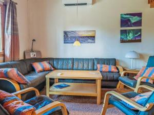 a living room with a couch and chairs at Holiday Home Teerenpesue e 37 by Interhome in Saariselka