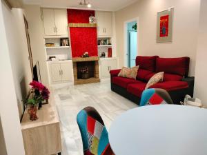 a living room with a red couch and a fireplace at Acogedor apartamento. Mezquita Wifi in Córdoba