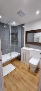 a bathroom with a shower and a toilet and a sink at Wastwater Cottage on The Big "W" Ranch in Nether Wasdale +61 photos
