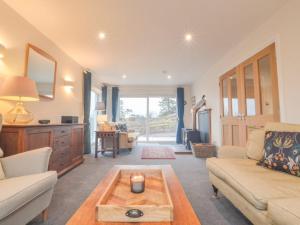 a living room with a couch and a coffee table at Holiday Home Blackmount House by Interhome in Oban
