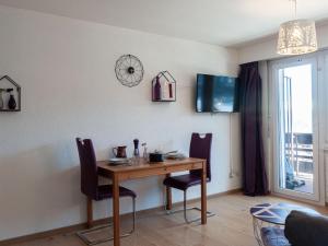 a dining room with a wooden table and chairs at Apartment Valaisia 24A by Interhome in Nendaz