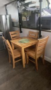 a wooden table and chairs with a green napkin on it at Dream Cottage in Castletownbere