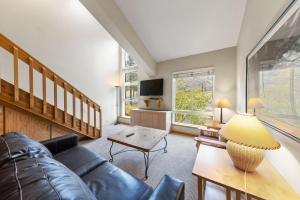 a living room with a couch and a table at Studio Loft #349 in Olympic Valley