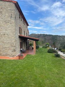 an outside view of a stone building with a patio at Podere il Poggio in Avaglio +44 photos