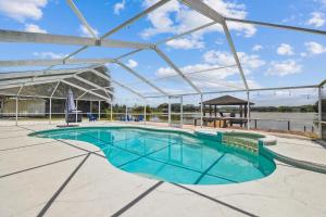 a large swimming pool with a gazebo in a building at Lake House Westchase area. Heated Pool Waterfront! in Tampa