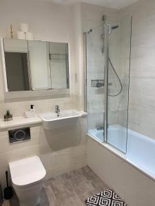 a bathroom with a sink and a toilet and a shower at Crawley 2bed Apartament close to Gatwick Airport in Copthorne