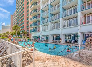 a group of people in a swimming pool at a hotel at Paradise 1408 in Myrtle Beach