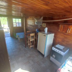 an overhead view of a kitchen with a refrigerator and a table at Cabaña El Mar in Barra del Chuy