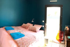 um quarto com uma cama com duas toalhas azuis em Villa aux portes de la presqu'ïle de Crozon em Plomodiern
