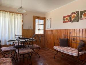 sala de estar con mesa y sillas en Cabañas & Camping Memoruz, en La Higuera
