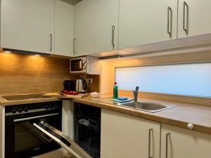 a kitchen with a sink and a counter top at Reload by BestChoice - FREE Parking - Self Check-in in Graz